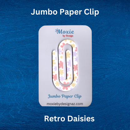 Colorful retro daisy design jumbo paper clip on a blue background, perfect for organizing papers.